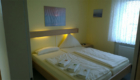 Kellenhusen Ferienhaus Nixe - Schlafzimmer eines Appartements mit Doppelbett